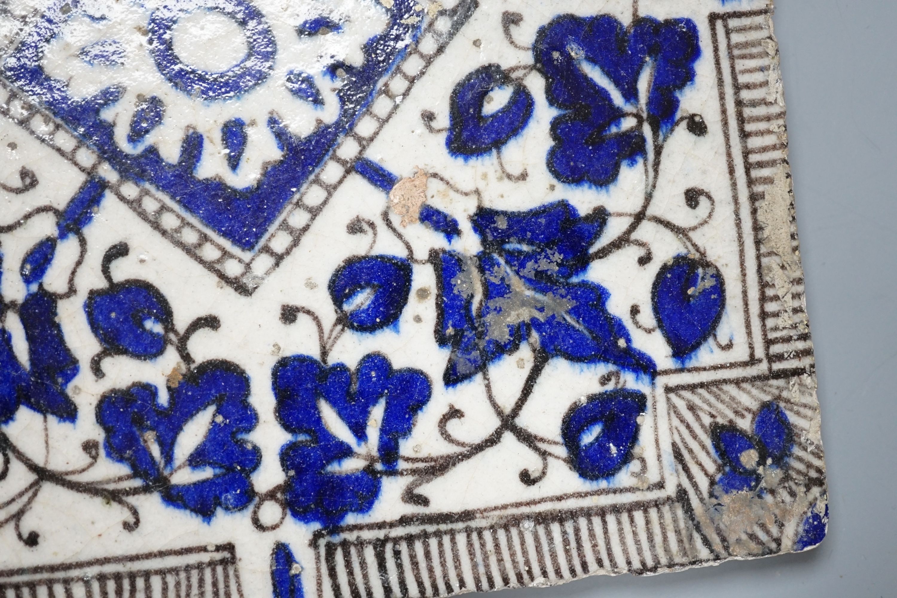 A Persian blue and white ceramic tile - 21 x 20cm